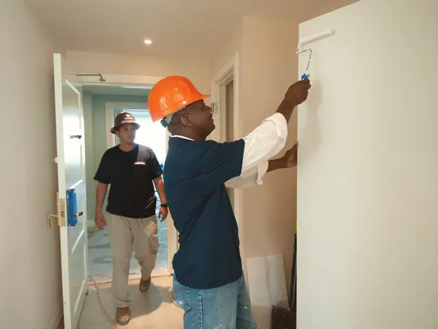 Remodeling crew in hard hats working inside a house